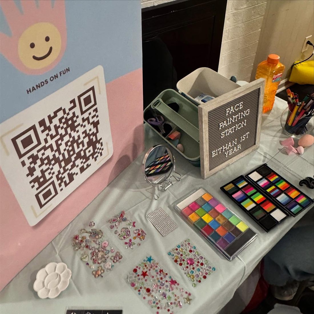 Face painting table with palettes, gems and brushes